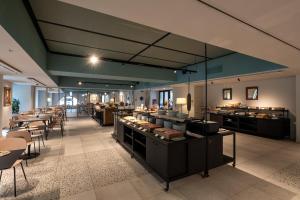 a restaurant with several tables and chairs and a cafeteria at Hotel Concord in Turin