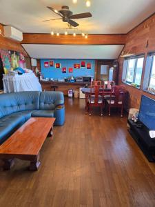 a living room with a couch and a table at Super Henro Inn in Nahari