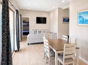 a dining room and living room with a table and chairs at Paradise Inn in Wildwood