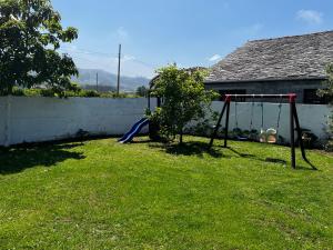 a yard with a swing set in the grass at Atico de madera Apartamento en Rinlo, RIBADEO in Ribadeo