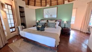 a bedroom with a large bed and green walls at Tulani Boutique Lodge - Includes Game drives and Meals in Grietjie Game Reserve