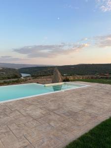 a swimming pool with a view of a mountain at Agriturismo B&B Casteldoria in Santa Maria
