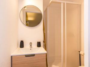 a bathroom with a sink and a mirror at Foral Guest House in Óbidos