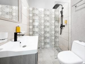 a bathroom with a white sink and a shower at Palace Bulevard Inn in Cluj-Napoca +66 photos