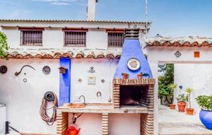 a house with a pizza oven in front of it at Casa La Seguiriya in Las Lagunillas