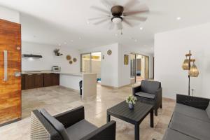 a living room with chairs and a ceiling fan at Tulum Paradise - Private Pool & Rooftop Deck in Tulum +118 photos