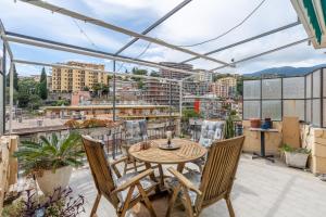 a patio with a table and chairs on a balcony at Casa Iris h Sanremo in Sanremo