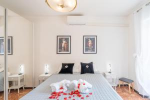a bedroom with a bed with stuffed animals on it at Casa Iris h Sanremo in Sanremo