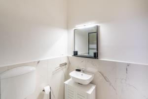 a white bathroom with a sink and a mirror at Casa Iris h Sanremo in Sanremo +14 photos