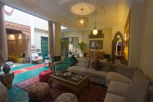a living room with a couch and a table at Riad Atrium & Spa in Marrakesh