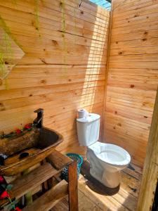 a bathroom with a toilet and a sink at Cabañas tipo glamping in Moniquirá +10 photos