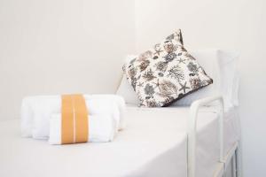 a white bed with two pillows on it at Monolocale Aurea 5 in Nardò