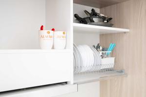 a kitchen pantry with plates and utensils at Monolocale Aurea 5 in Nardò