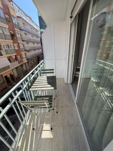 two chairs and a table on a balcony of a building at Fleming Center in Benidorm