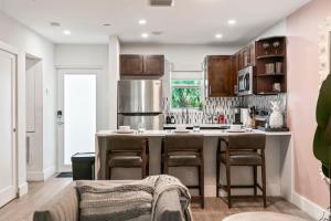 a kitchen with a large island with bar stools at King Suite, Private Beach Path, Pool & Hot Tub in Boca Raton