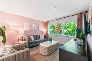 a living room with a couch and a table at King Suite, Private Beach Path, Pool & Hot Tub in Boca Raton