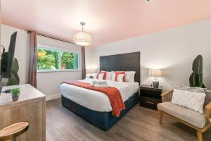a bedroom with a large bed and a chair at King Suite, Private Beach Path, Pool & Hot Tub in Boca Raton +22 photos