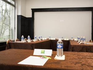 a bottle of water sitting on top of a table at Ibis Styles Metz Centre Gare in Metz +24 photos