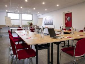 a conference room with a table with a laptop on it at IBIS Cannes Mouans Sartoux Piscine parking gratuit in Mouans-Sartoux +101 photos