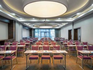 a large room with tables and chairs in a room at Novotel Kayseri in Kayseri