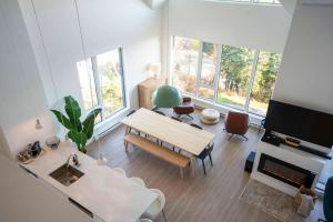 a living room with a table and a couch at 411 - Luxury Condo - Incredible View & Pool in Baie-Saint-Paul +58 photos
