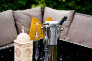 a blender on a table with a bottle of wine at Edwardian Cottage in beautiful surroundings with hot tub in Slinfold