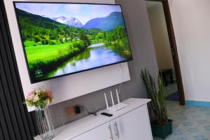 a flat screen tv hanging on a wall at Larami House Narok in Narok