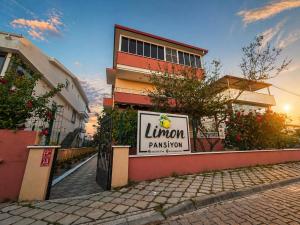 a building with a sign for a luton pharmacy at Limon Pansiyon Burhaniye in Burhaniye