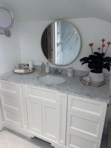 a bathroom with a white sink and a mirror at Wendys house in Sarisbury Green +60 photos