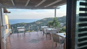 a patio with tables and chairs on a balcony at Villa Asia Relais in Massa Lubrense