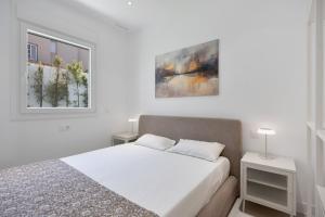 a white bedroom with a bed and a window at Complejo Los Drogos in Novo Sancti Petri +116 photos