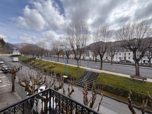 a view from a balcony of a street with trees at Résidence la Plage in La Bourboule