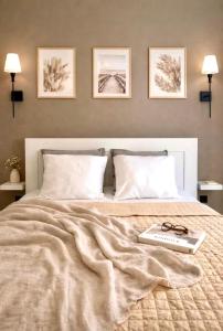 a bed with a book and glasses on it at Shanti - Sérénité in Esch-sur-Alzette