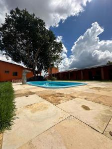 a swimming pool in a yard with a tree at Pousada sonho real in Barreirinhas