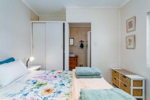 a bedroom with a bed and a bathroom at Barnacle Tree in Somerset West