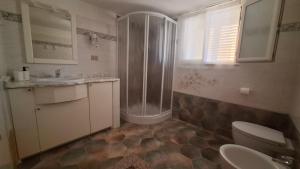 a bathroom with a shower and a toilet and a sink at Phiniscollis B&B in La Caletta +72 photos