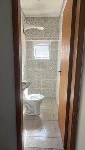 a bathroom with a toilet and a window at Sobrado em volta do lago in Lindóia +9 photos