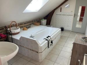 a large bathroom with a tub and a sink at Le champ de l alouette in Bec-de-Mortagne