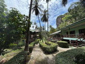 a resort with a building and palm trees at Chill Out Bar and Bungalows in Tonsai Beach