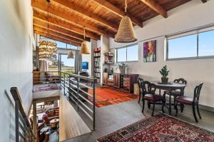 a living room with a table and a dining room at Jubilee in Buffelsbaai