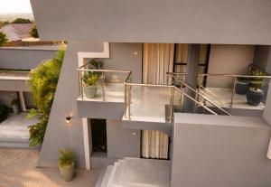 an external view of a building with stairs and potted plants at Care Appartement in Kinshasa