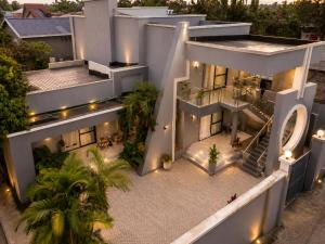 an aerial view of a white building with lights at Care Appartement in Kinshasa