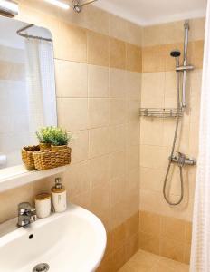 a bathroom with a sink and a shower at Starry Coast Apartments in Nea Potidaea +54 photos