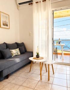 a living room with a couch and a table at Starry Coast Apartments in Nea Potidaea