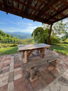 a wooden picnic table sitting under a roof at Costa Alta - Casa Vacanze in Arcevia