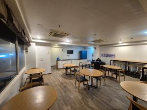 a restaurant with tables and chairs and a counter at GH Brother Eureka in Guwahati