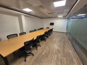 a large conference room with a long table and chairs at GH Brother Eureka in Guwahati