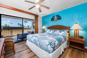 a bedroom with a bed and a balcony at Kona Plaza#409 in Kailua-Kona +61 photos