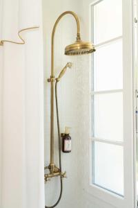 a shower in a bathroom next to a window at Maison Chambre et Jardin in San Martino in Rio