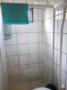 a bathroom with a shower with a green towel at Residencia Siqueira in Garopaba +11 photos